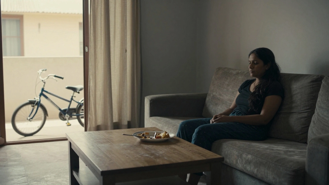 A woman sits silently on a sofa in a dim room, untouched food beside her, symbolizing the invisible burden of depression.